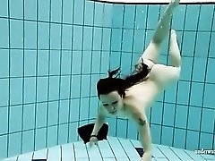 Brunette jumps in the pool fully dressed